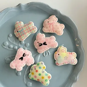 Detail showing six assorted cute resin rabbit hair clips in macaron colors and floral patterns