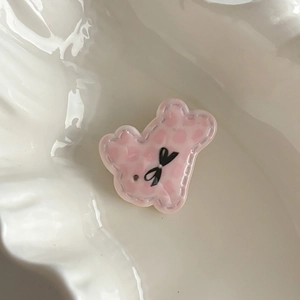Cute pink resin bear hair clip with quilted texture and bow detail for girls