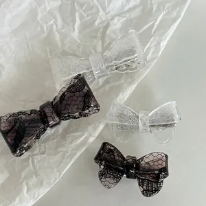 Vintage acrylic lace bow hair clips in black and white mesh patterns for women