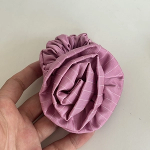 Pink rose flower scrunchie with white stripes made of soft fabric for elegant hairstyles