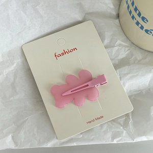 Cute matte pink bear acrylic hair clip for women displayed on a white paper card
