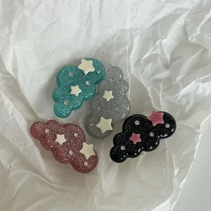 Detail of cloud-shaped glitter hair clips in four colors with star and rhinestone accents