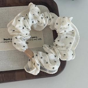 Elegant polka dot organza hair scrunchie in cream white with a decorative pearl bead