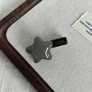 Close-up of star acetate hair clip with FRANCE Handmade engraving and metal side view