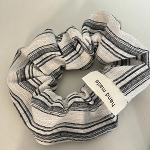 Retro black and white striped scrunchie with a handmade label for ponytail styling