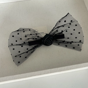 Elegant black polka dot mesh bow hair clip with rose decoration on beige base