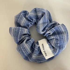 Blue striped oversized scrunchie with handmade woven label for elegant ponytail hair styling