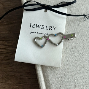 Silver hollow double heart hair clip with colorful dots and ribbon on white card