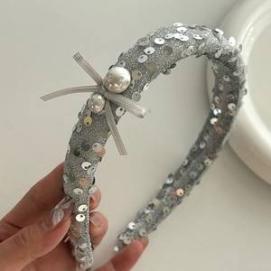 Elegant silver sequin headband with a grey ribbon bow and pearls for hair styling