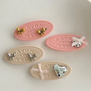 Pink ribbon bow heart stud earrings in gold and silver finish for a sweet girls look