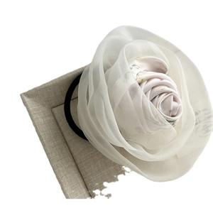 Elegant floral hair tie featuring layered white mesh and pink rose fabric at 45 degree angle