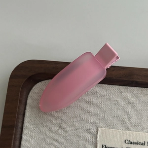 Close-up of a matte pink jelly acrylic hair clip with a minimalist duckbill design