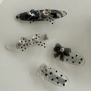 Set of four black and white lace polka dot acrylic bow hair clips for women