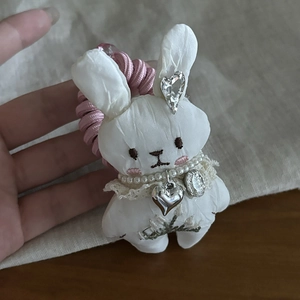 Cute white bunny plush hair tie with pink spiral cord and shiny pearl necklace