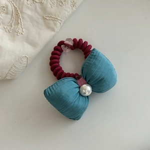 Pastel blue bow hair tie with pearl accent and burgundy spiral telephone wire band