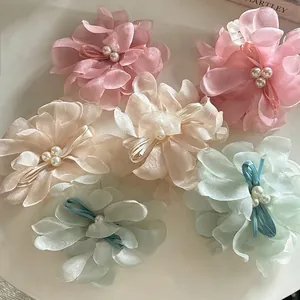 Elegant floral mesh hair claws with pearls and ribbons in soft pink and cream tones