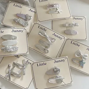 Ensemble de barrettes argentées nœud et étoile pour filles avec textures pailletées