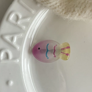 Macro shot of jelly colored fish hair clip with purple and pink gradient resin texture