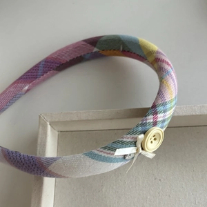 Plaid checkered headband with bow and button detail in vintage preppy style for women