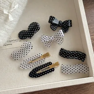 7-piece black and white polka dot hair clip set with acrylic bows and hearts