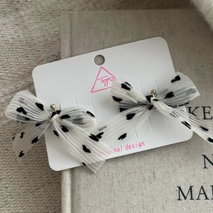 Set of two white chiffon mesh bow hair clips with black heart patterns for children