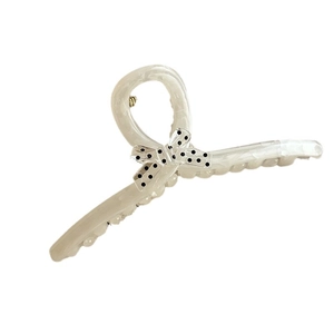 Pince à cheveux crème à pois avec nœud papillon et design torsadé rétro élégant