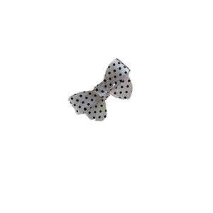 Minimalist white satin polka dot bow hair clip with decorative wavy edges and duckbill grip