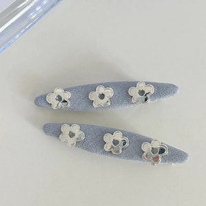 Set of two light blue fabric hair clips with silver hollow flower and heart charms
