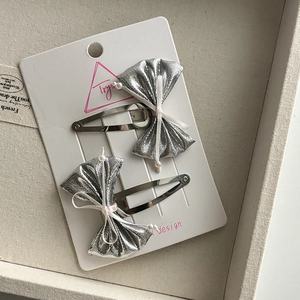 Sparkly silver bow hair clips for girls featuring faux pearls and metallic BB clips