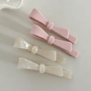 Minimalist bow hair clips set in pink and pearl white glossy acetate finish for women