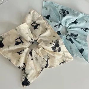 Panda and bamboo pattern scrunchies in beige and light blue silk-like fabric