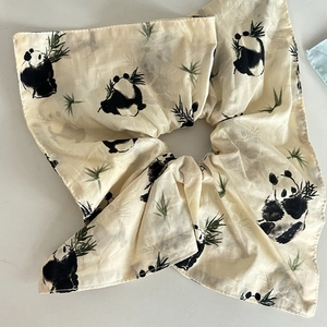 Detailed view of beige panda bamboo silk scarf scrunchie with ink painting style artwork