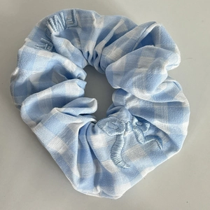 Blue and white checkered scrunchie with bow embroidery and soft fabric texture