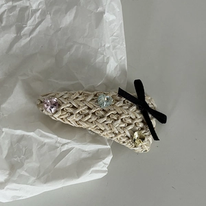 Handwoven straw teardrop hair clip with heart crystals and a black velvet bow accent