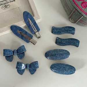 7-piece blue denim texture hair clip set featuring bows and wavy metal duckbill clips