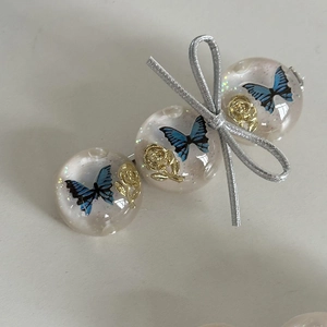Blue embossed butterfly hair clip with resin beads and gold rose accents