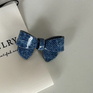 Glossy dark blue denim texture bow hair clip on minimalist white jewelry gift bag