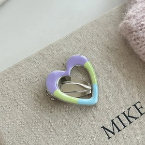 Sweet cream colored heart-shaped hair clip with purple and lime green enamel on silver metal