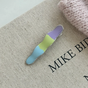 Cream color wave hair clip with pastel purple green and blue enamel drip glaze finish