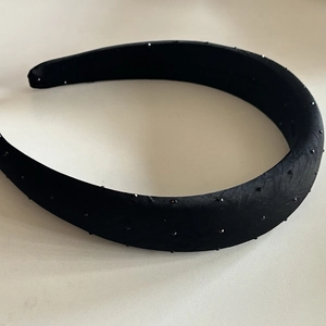 Padded black polka dot headband with sparkling rhinestones and elegant satin finish