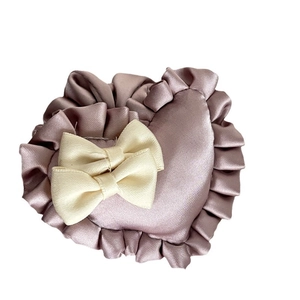 Mauve heart-shaped satin scrunchie with cream bow detail for bun hairstyles