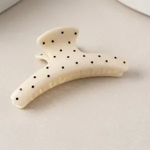 French style white acetate claw clip with black polka dots and crescent shape design