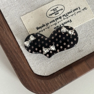 Sweet polka dot heart hair clip with rhinestone bows in a vintage wooden tray
