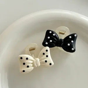 Polka dot bow hair claws in black and cream for women, elegant resin hair accessories
