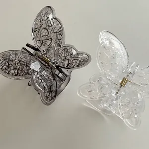 Lace-textured butterfly hair claw clips in black and clear acrylic for women