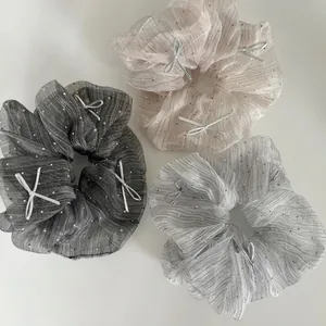 Three sparkly mesh scrunchies with silver bows in black, champagne and grey colors