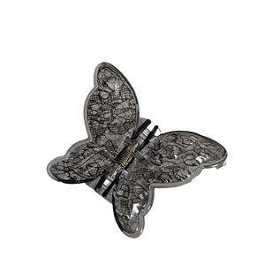 Vintage lace-style butterfly hair claw clip with black mesh pattern on transparent base