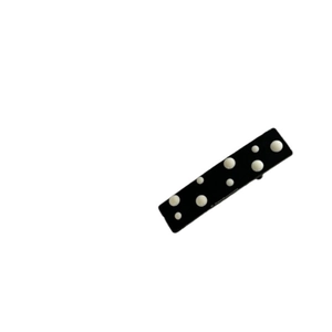 Polka dot hair clip with white pearls on black rectangular acrylic base for women