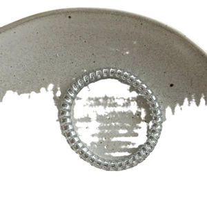 Silver spiral telephone wire hair tie with a sleek metallic finish for women