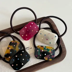 Elegant acetate hair scrunchies with colorful rhinestones in five diverse patterns